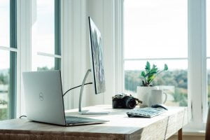 Desk with design laptop and desktop